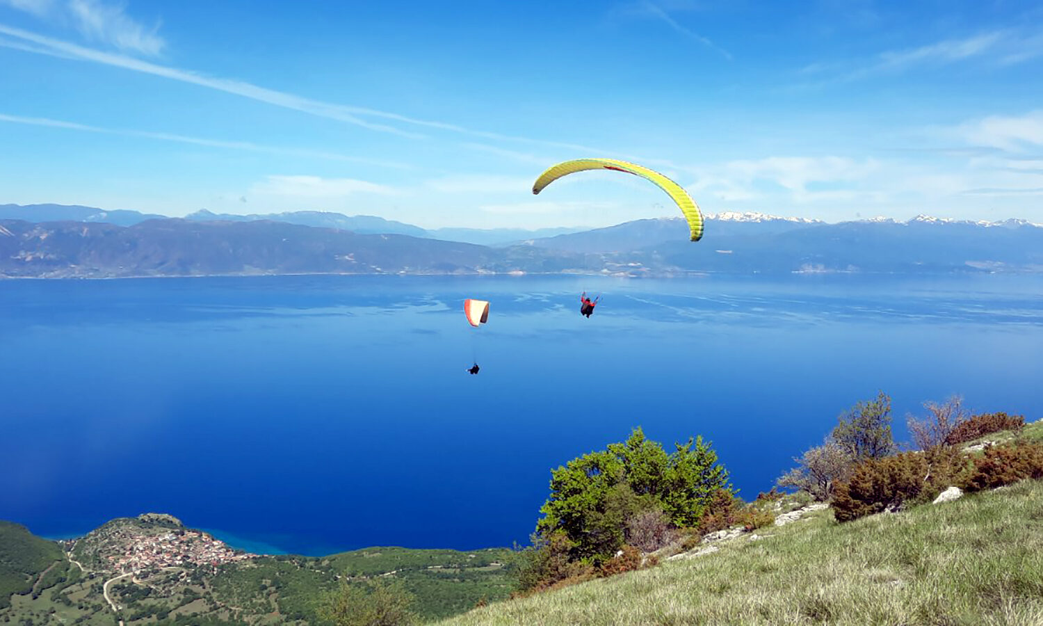 Two paragliders soaring at the take-off at Galicica Ohrid